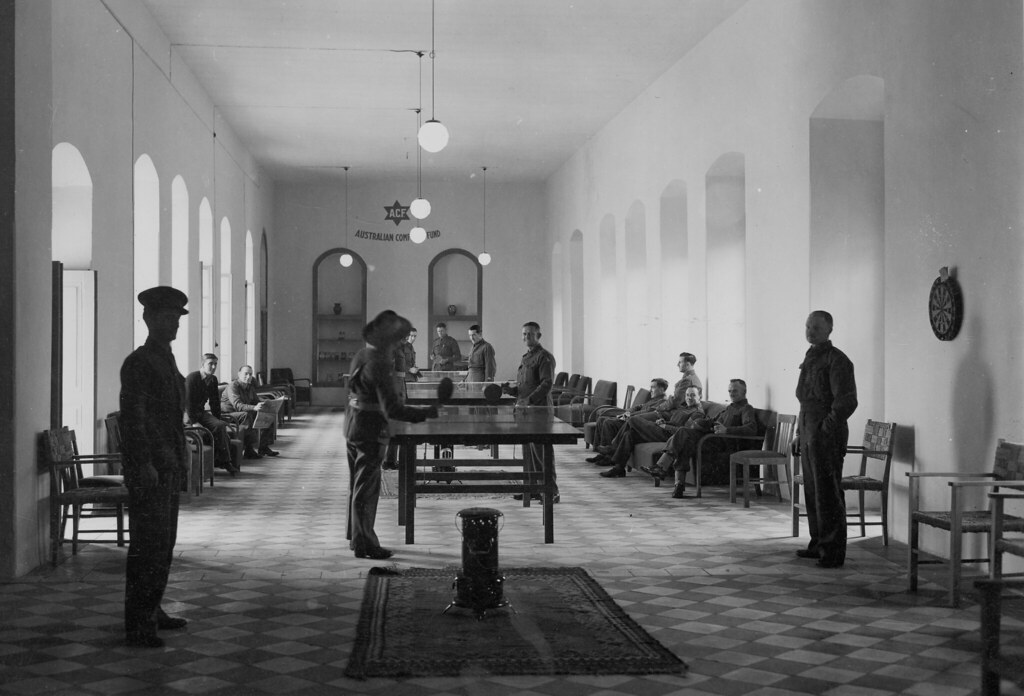 Servicemen in interior of the Australian Comforts Fund Hostel playing ping pong in the 19th century